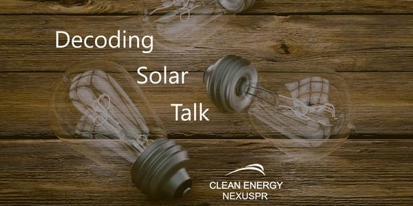 Decoding Solar Talk text over antique lightbulbs resting on wood planks